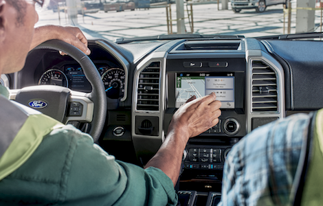 Interior of the Ford F-150 Two construction workers using the SYNC System in the Ford F-150