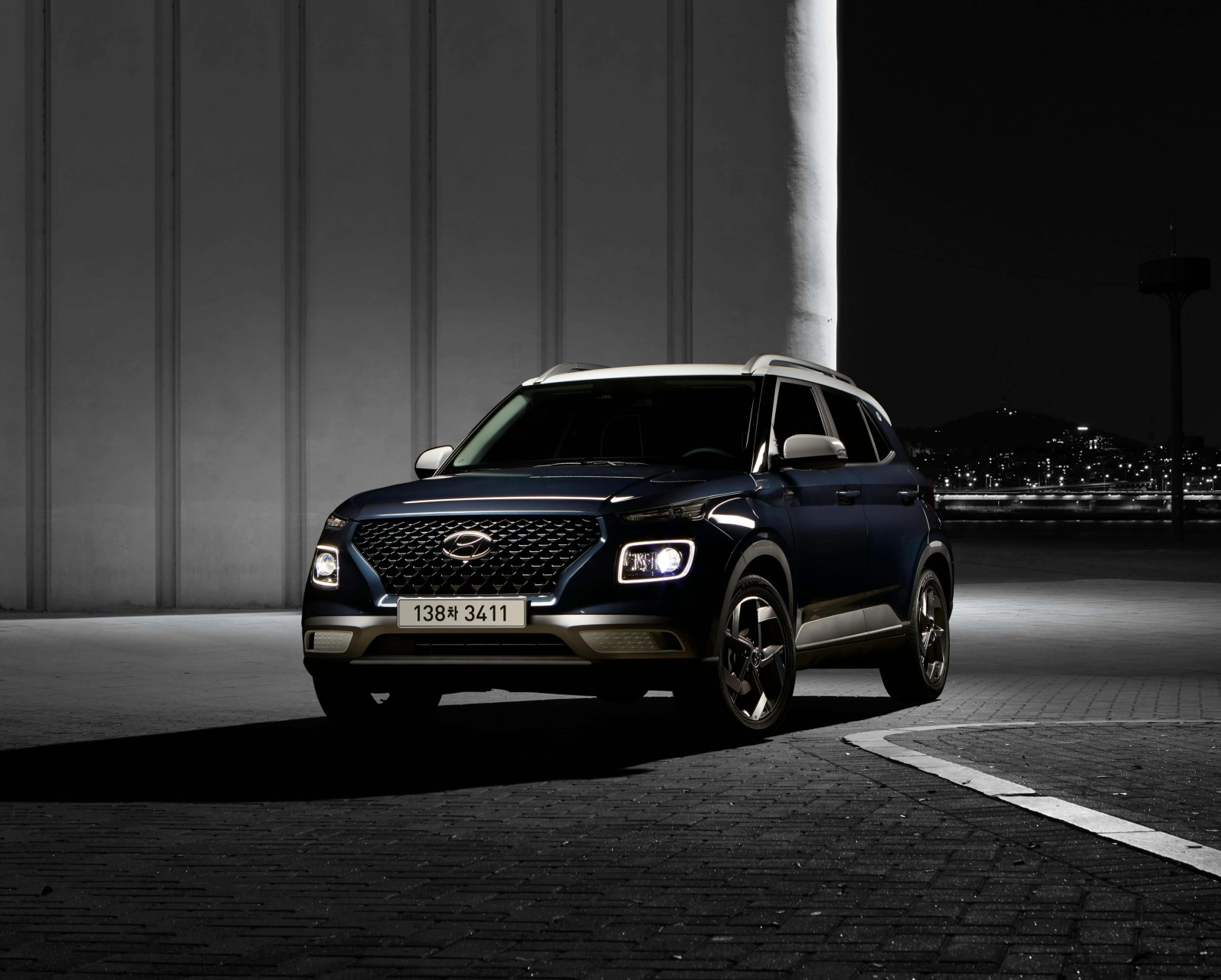 A Hyundai Venue parked on a city street.