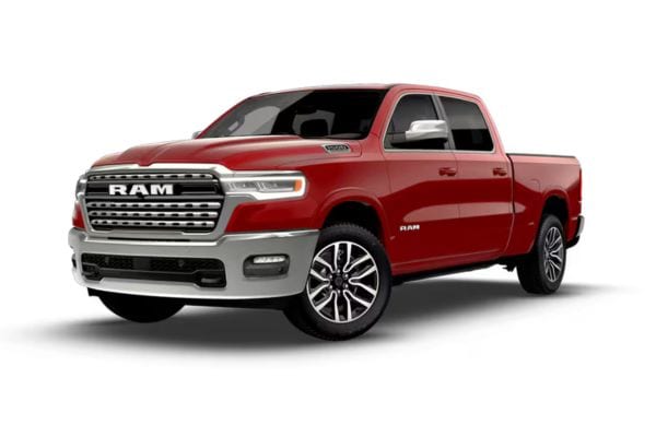 Front three-quarter view of a red 2026 RAM 1500 Limited Longhorn luxury truck featuring premium chrome grille styling and polished multi-spoke wheels.