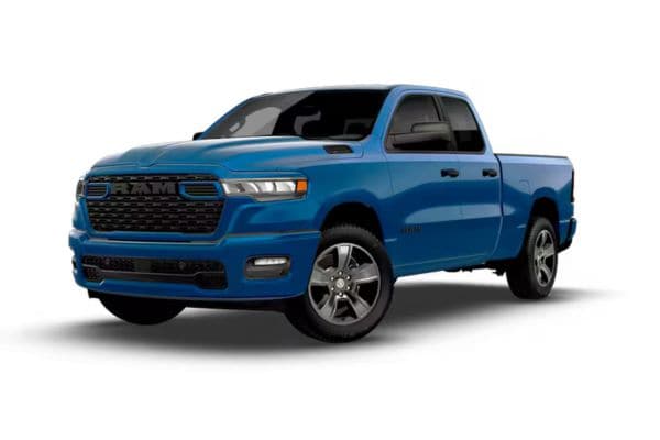 Front three-quarter view of a blue 2026 RAM 1500 Tradesman HFE high fuel efficiency model featuring body-color bumpers and upgraded aluminum wheels.