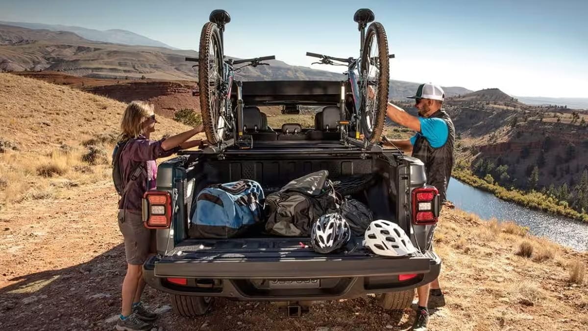 Jeep Gladiator parked outdoors with recreational gear in the truck bed