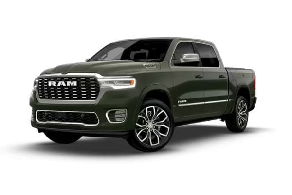 Front three-quarter view of a dark green 2026 RAM 1500 Tungsten premium flagship flagship luxury truck featuring a bespoke platinum grille mesh and elite 22-inch wheels.