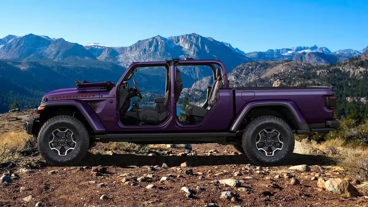 Jeep Gladiator Rubicon with its roof and doors removed on a rocky trail