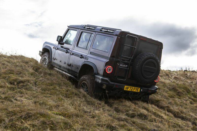 INEOS Grenadier driving off-road up a steep grassy hill