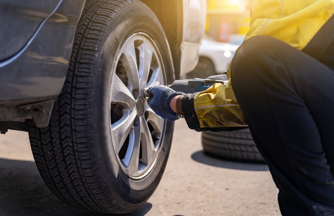 A engineer replacing a vehicle's tires.