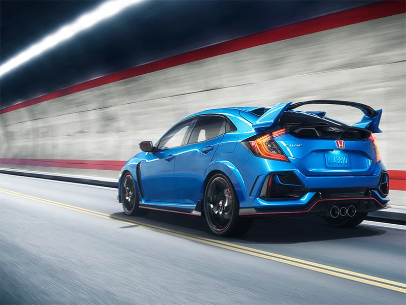 A blue Honda Civic Type R driving on a road.