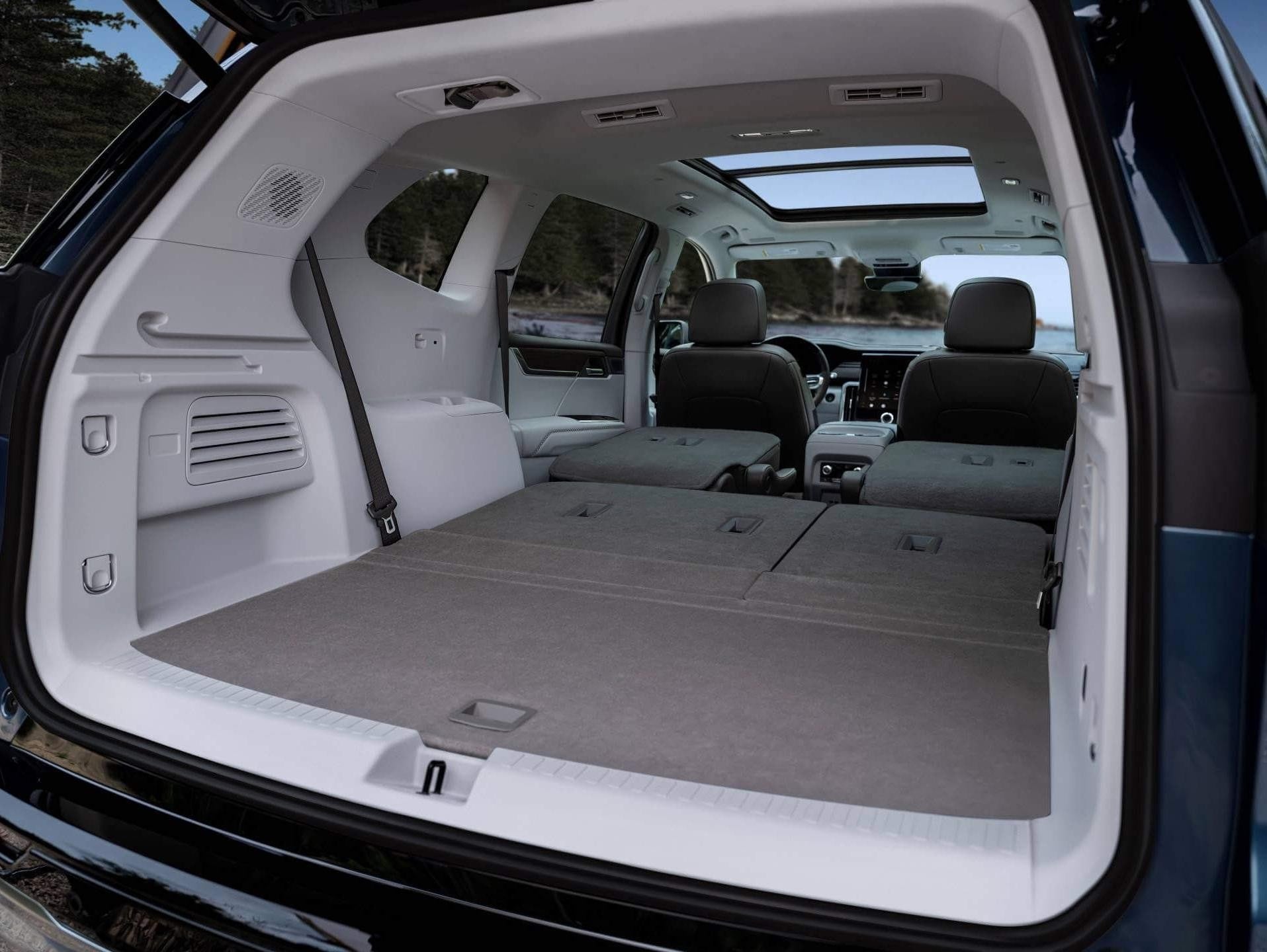 GMC Acadia with two rows of seats folded down, showcasing storage
