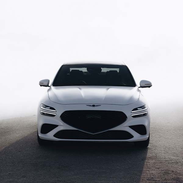 Model Features of the 2022 Genesis G70 at Genesis of York | Front View of White 2022 Genesis G70 in Foggy Weather
