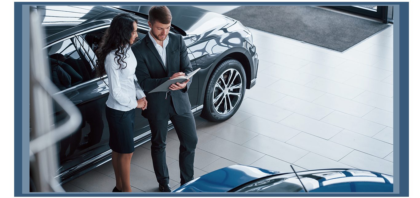 Things to Bring with you to Purchase a Car at Jack Giambalvo Hyundai in York, PA | Sales person in black suit showing car paper work to customer 