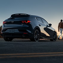 Model Features of the 2021 Mazda3 at Jack Giambalvo Mazda | Close up of Mazda3 from behind parked