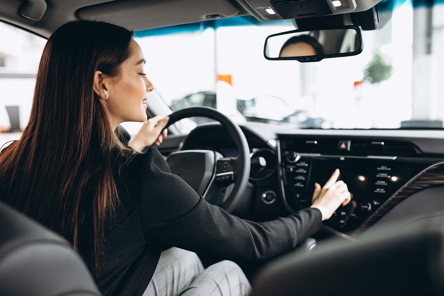 Leasing versus Buying a Mazda at Jack Giambalvo Mazda in York, PA | Woman testing out car in showroom