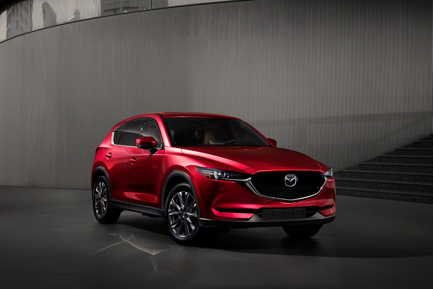 the 2021 Mazda CX-5 versus the 2021 Ford Escape at Jack Giambalvo Mazda of York | 2021 Mazda CX-5 parked in front of a building