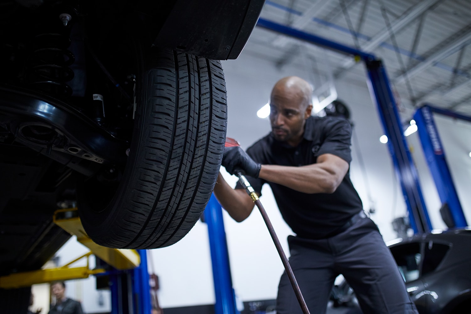 How to Check your Tires' Health at Jack Giambalvo Mazda | Mazda service technician replacing tire on Mazda vehicle