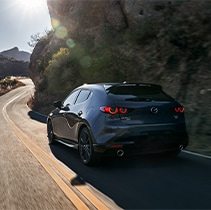 Model Features of the 2021 Mazda3 at Jack Giambalvo Mazda | Close up of Mazda3 from behind driving
