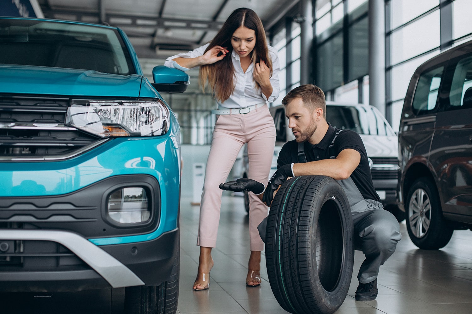 What is a Tire Rotation? at Jack Giambalvo Mazda | Mazda service technician explainging to customer why she should get her tires rotated