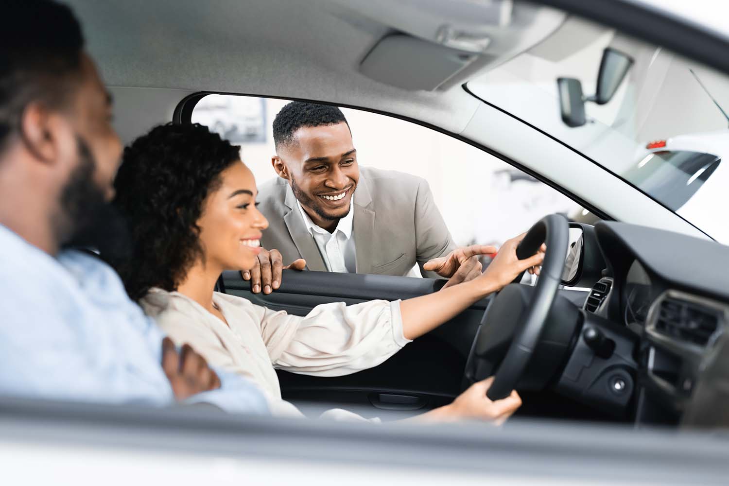 Leasing versus Buying a Mazda at Jack Giambalvo Mazda in York, PA | Couple testing out vehicle in the showroom
