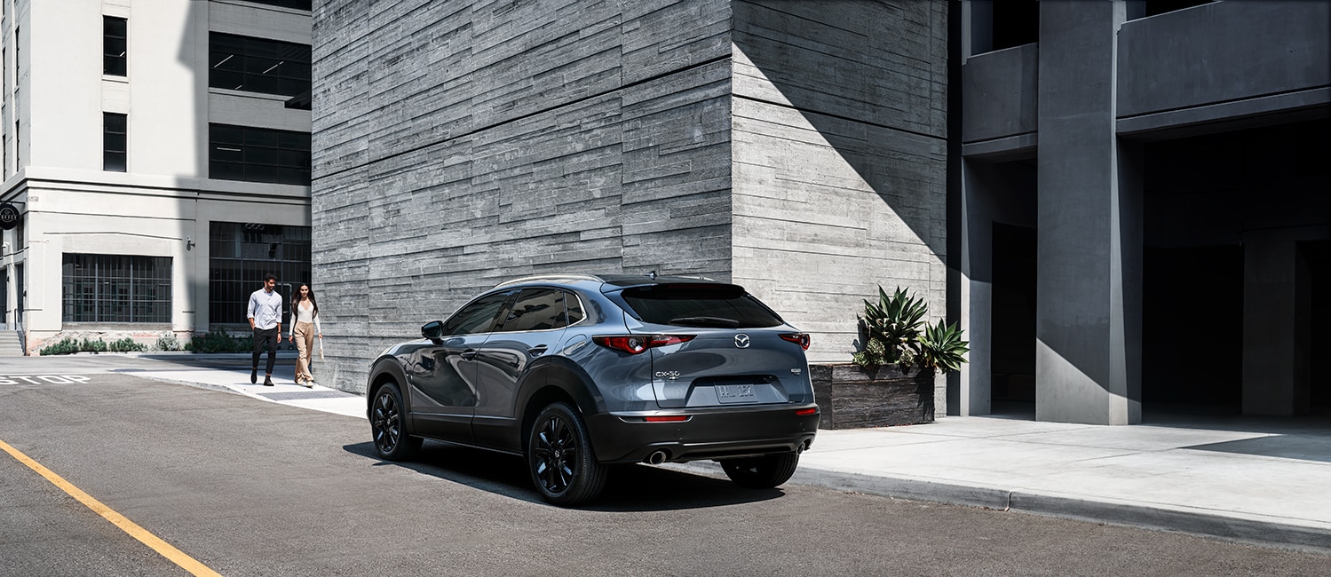 Compare the 2021 Mazda CX-30 vs. the 2022 Honda HR-V at Jack Giambalvo Mazda | 2021 Mazda CX-30 parked by building