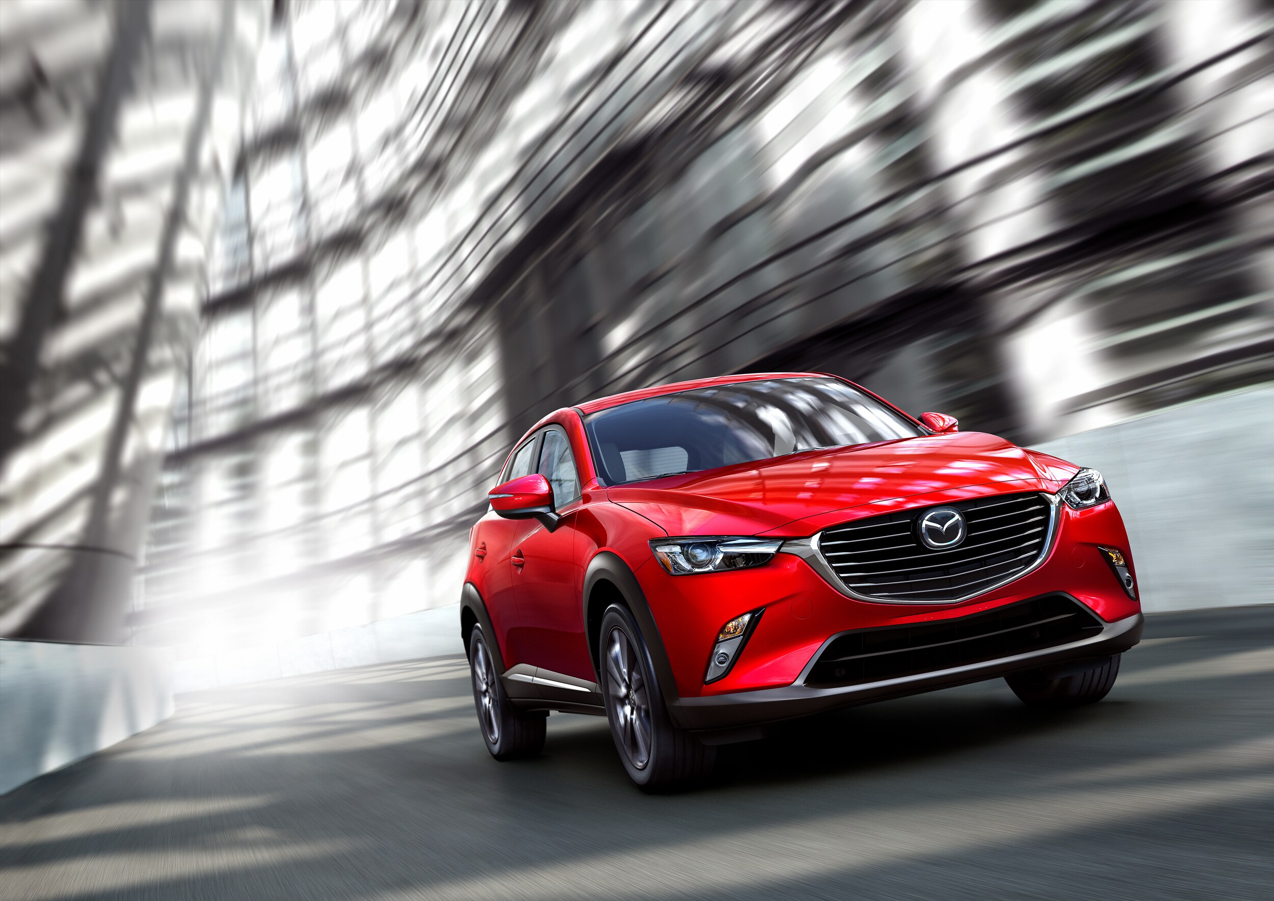 Jack Giambalvo Mazda is a Car Dealership near Shiloh, PA | 2020 Mazda CX-3 driving fast under architecture