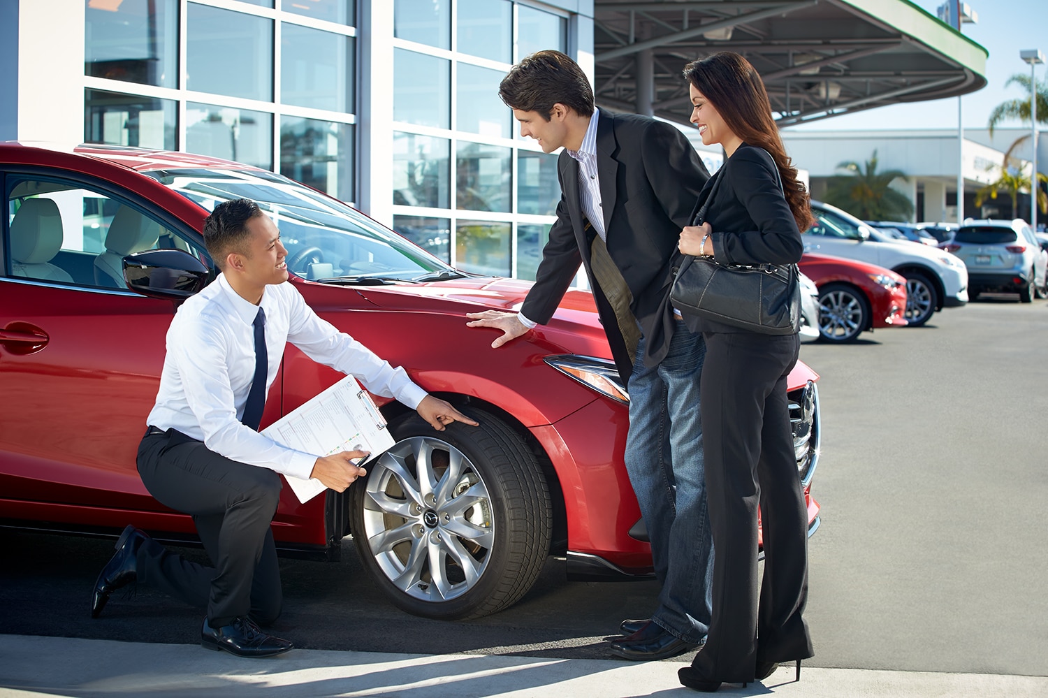 How to Check your Tires' Health at Jack Giambalvo Mazda | Mazda sales associate showing customers tire tread on new Mazda