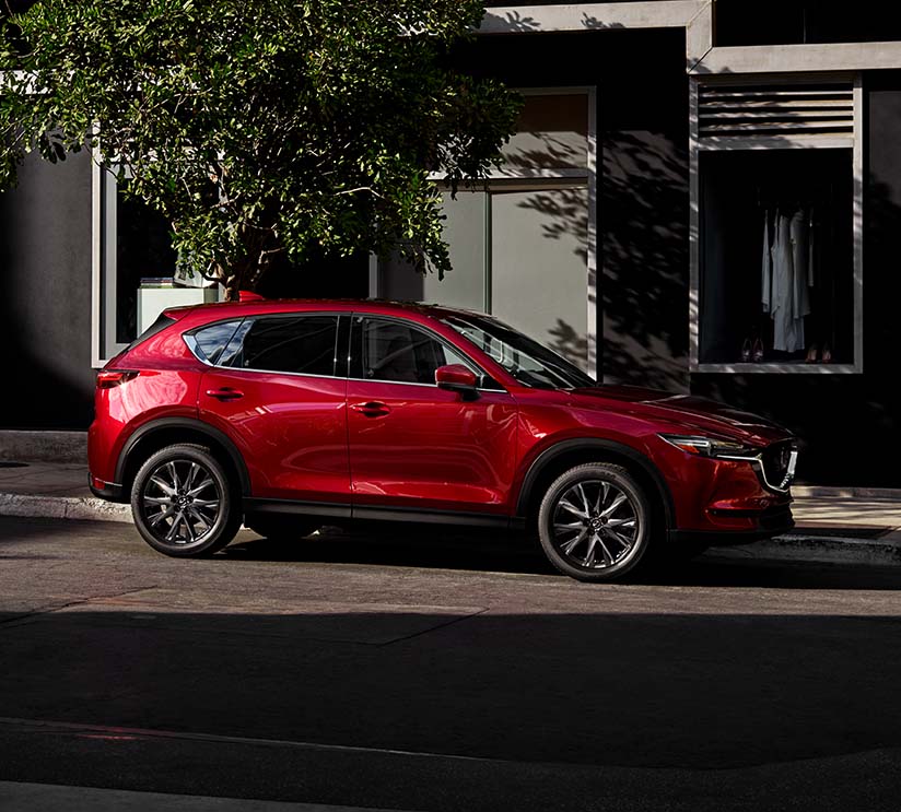 Model Features of the 2021 Mazda CX-5 at Jack Giambalvo Mazda | Red 2021 Mazda CX-5 Street Parked in City
