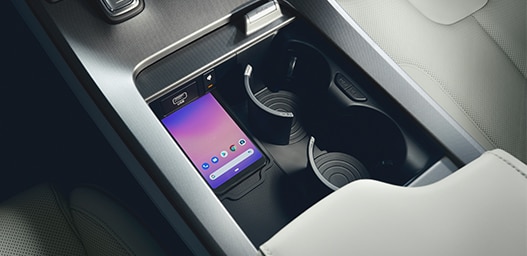 Compare the 2021 Hyundai Palisade vs. the 2021 Toyota Highlander at Jack Giambalvo Hyundai | Center console with two cup holders and place for phone