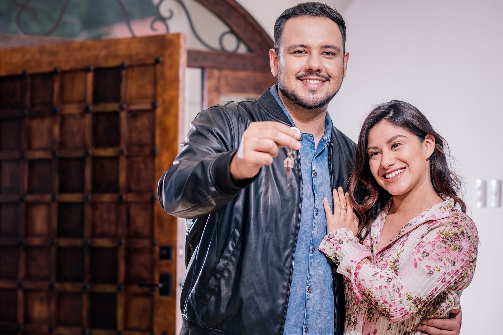 Hispanic Couple with Keys to New Acura Vehicle