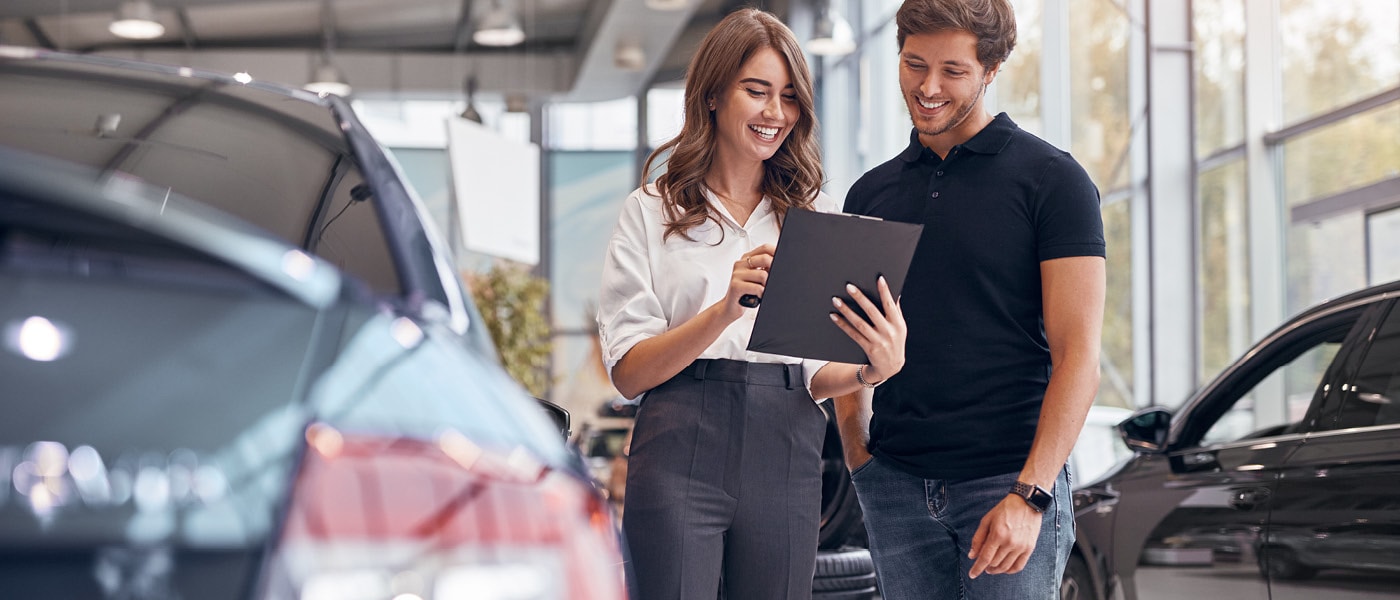 Customer and Jaguar employee reviewing clipboard