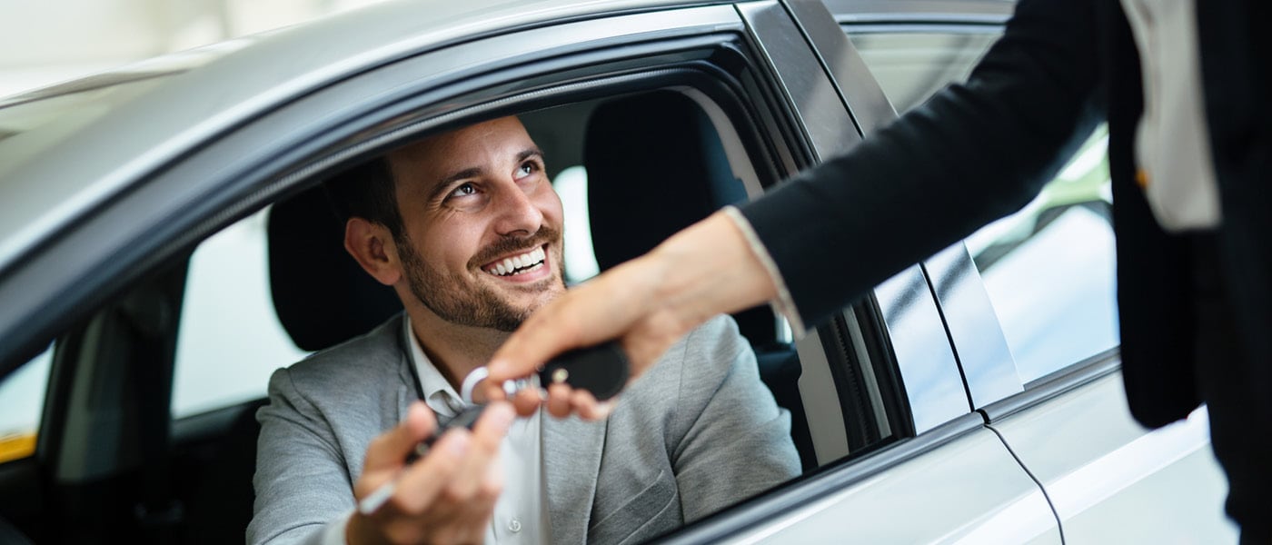 Driver receiving keys to Jaguar