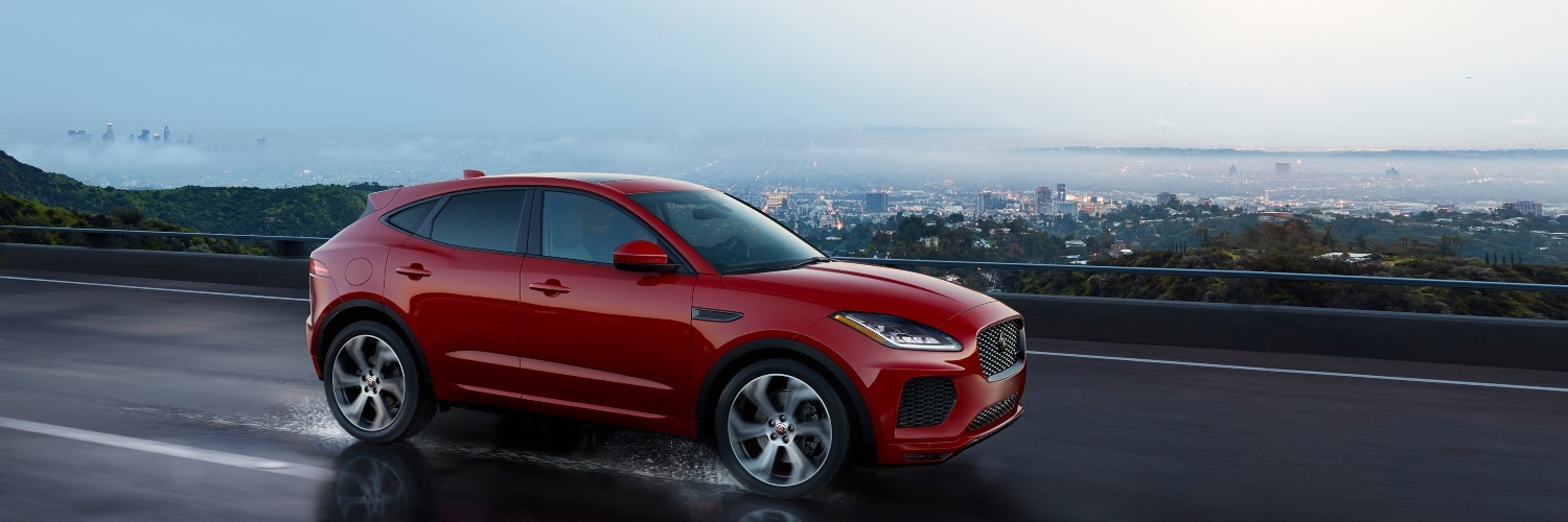 Jaguar E-PACE driving down scenic city road