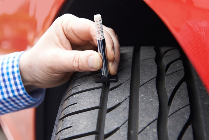 Checking_Car_Tire_With_Gage.jpg
