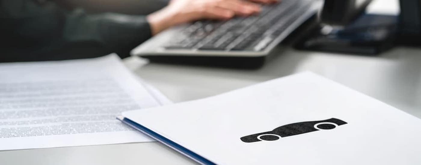 Paperwork is shown on a table at a dealership after someone asked to 'value their trade.'