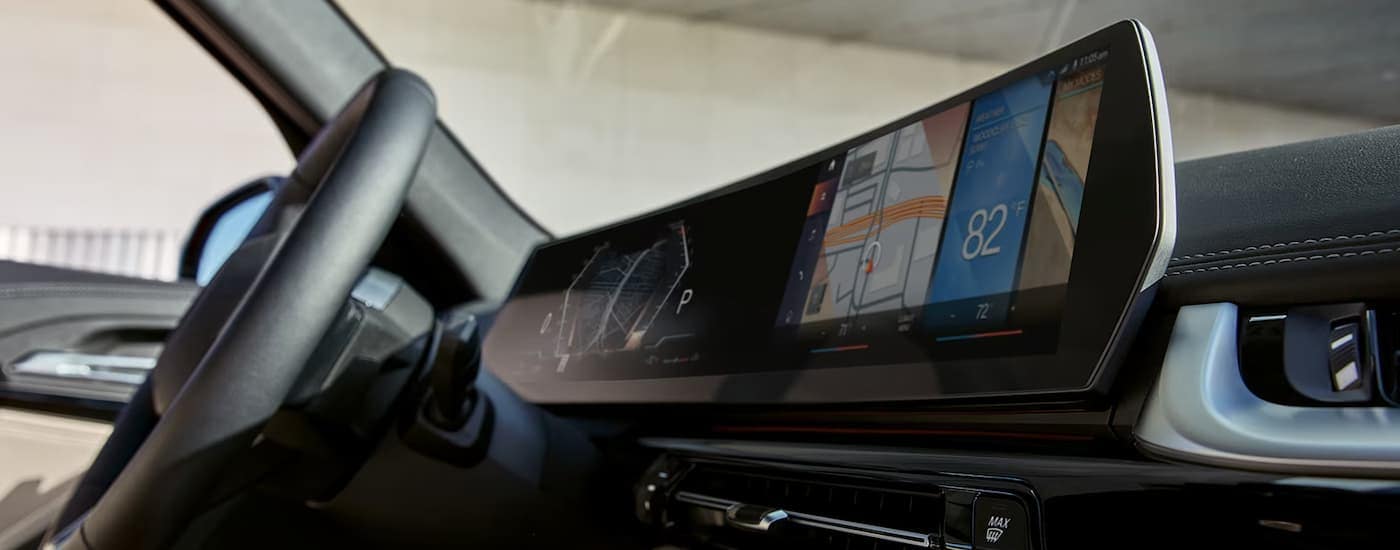 The infotainment screen and center console of a 2023 BMW X1is shown at a Norwood BMW store.
