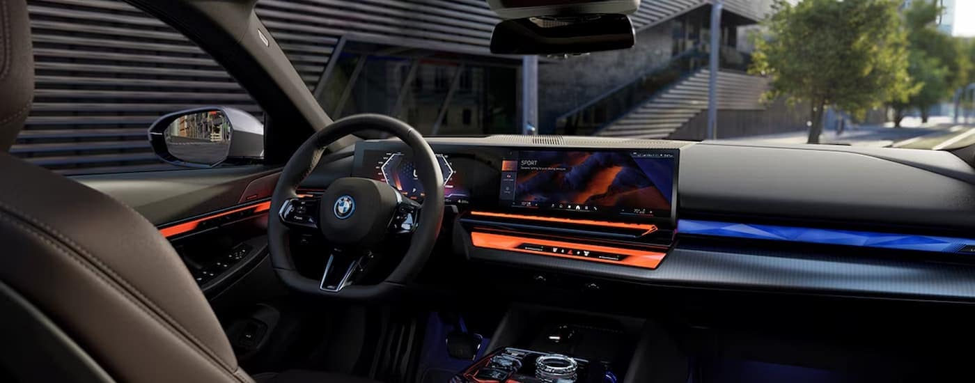 The black and orange accented interior of a 2023 BMW i5 is shown at a BMW store in Cincinnati.