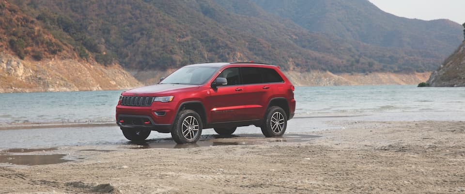 Jeep Cherokee A red Jeep Cherokee parked by a lake