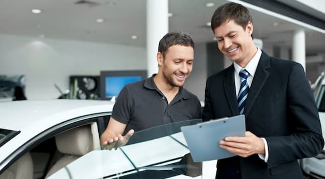 A man explaining car financing to a client