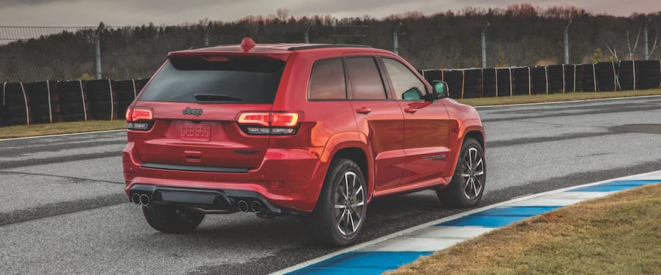 2019 Jeep Grand Cherokee A red 2019 Jeep Grand Cherokee driving on a track