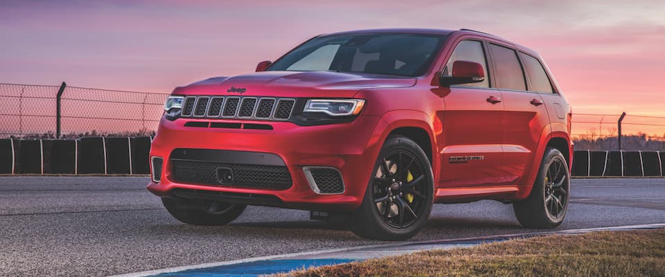 2019 Jeep Grand Cherokee A red 2019 Jeep Grand Cherokee on a track at sunset
