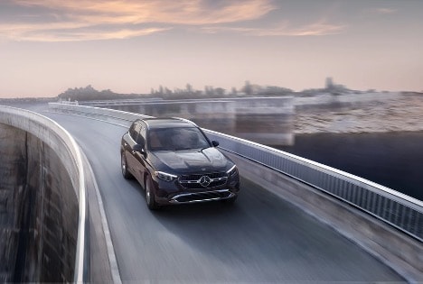 2026 Mercedes-Benz GLC driving on a bridge at sunset