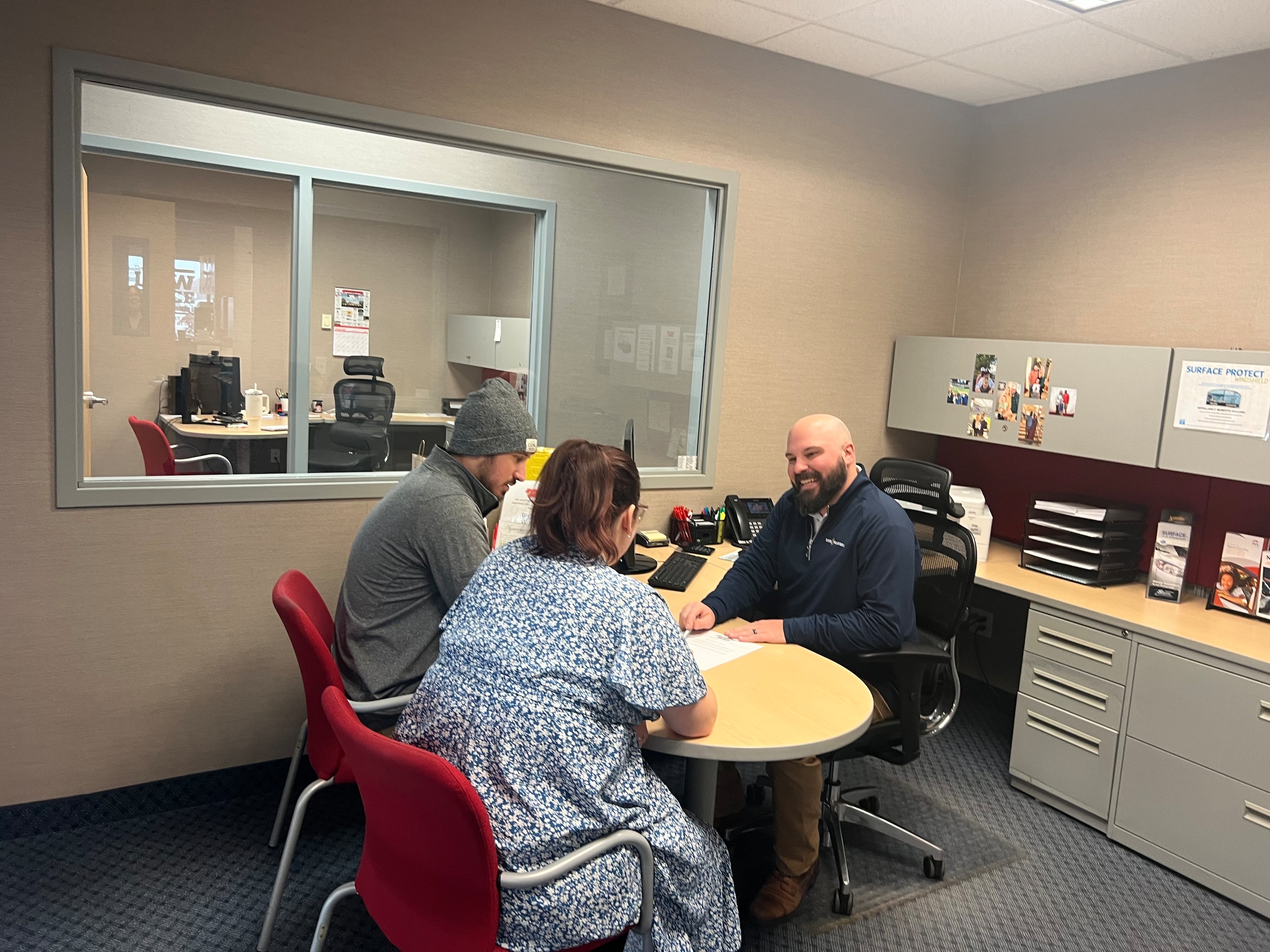 Finance manager Nick Betker reviewing vehicle paperwork with customers at Jay Malone Ford in Hutchinson, Minnesota