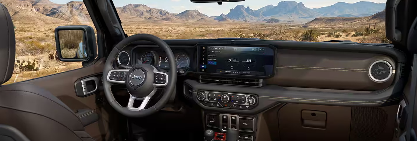 Interior of the 2027 Jeep Wrangler Laredo showing the Bison Brown cabin with Mayan Gold stitching and Global Black contrast surfaces