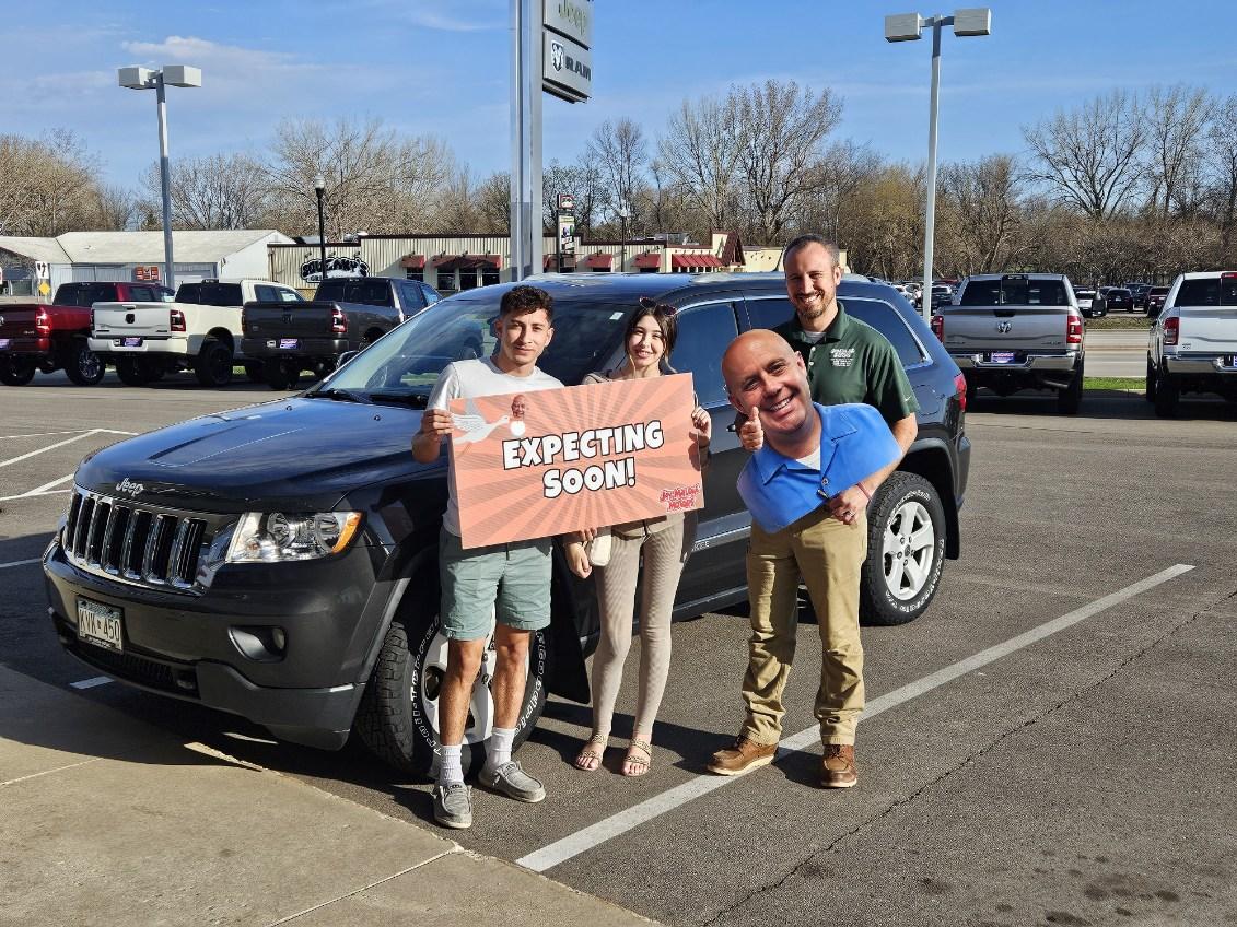 Happy Jay Malone CDJR customer with their used Jeep Grand Cherokee in Hutchinson MN