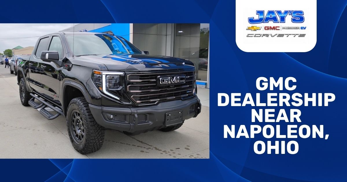 Black 2026 GMC Sierra 1500 AT4X pickup truck parked outside Jay’s Chevrolet GMC dealership, alongside blue promotional text reading “GMC Dealership Near Napoleon, Ohio” with Jay’s Chevrolet, GMC, Hummer EV, and Corvette branding.