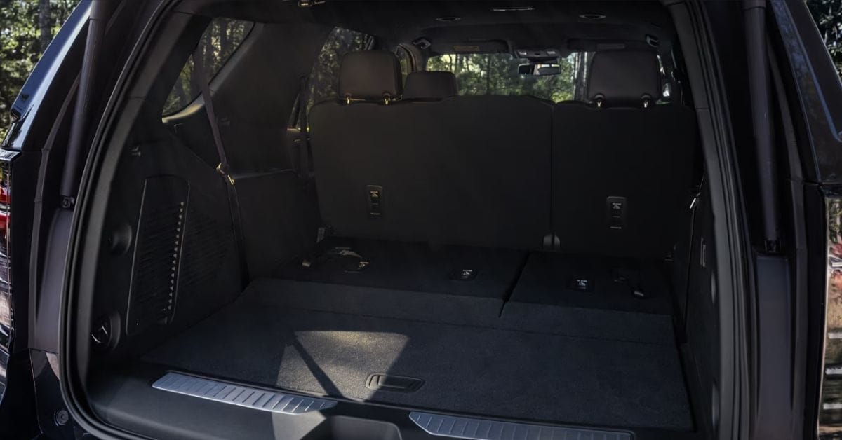 Interior view of a 2026 Chevrolet Tahoe cargo area showing folded rear seats and expanded.