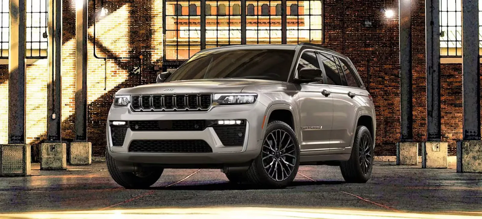 Silver Jeep Grand Cherokee exterior shown in an urban showroom-style setting in Las Vegas