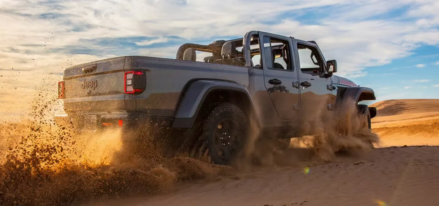 Used Jeep Gladiator Las Vegas Desert Sand Used Jeep Gladiator driving through desert sand near Las Vegas
