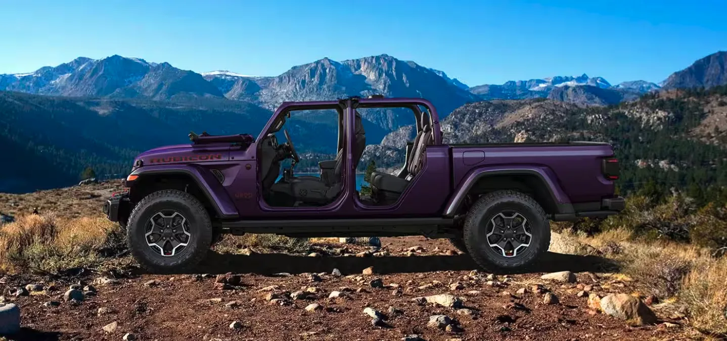 Purple Jeep Gladiator Rubicon parked on a mountain trail with the doors and roof removed