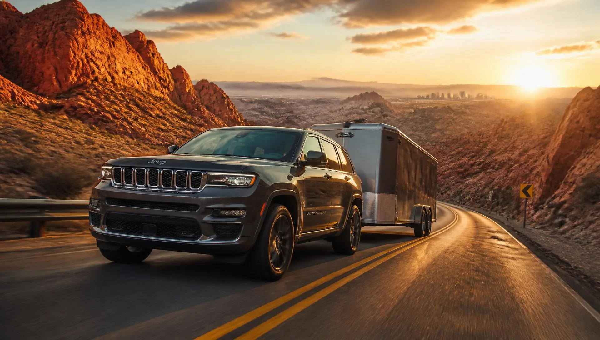 Jeep Grand Cherokee towing a trailer up a desert grade near Las Vegas
