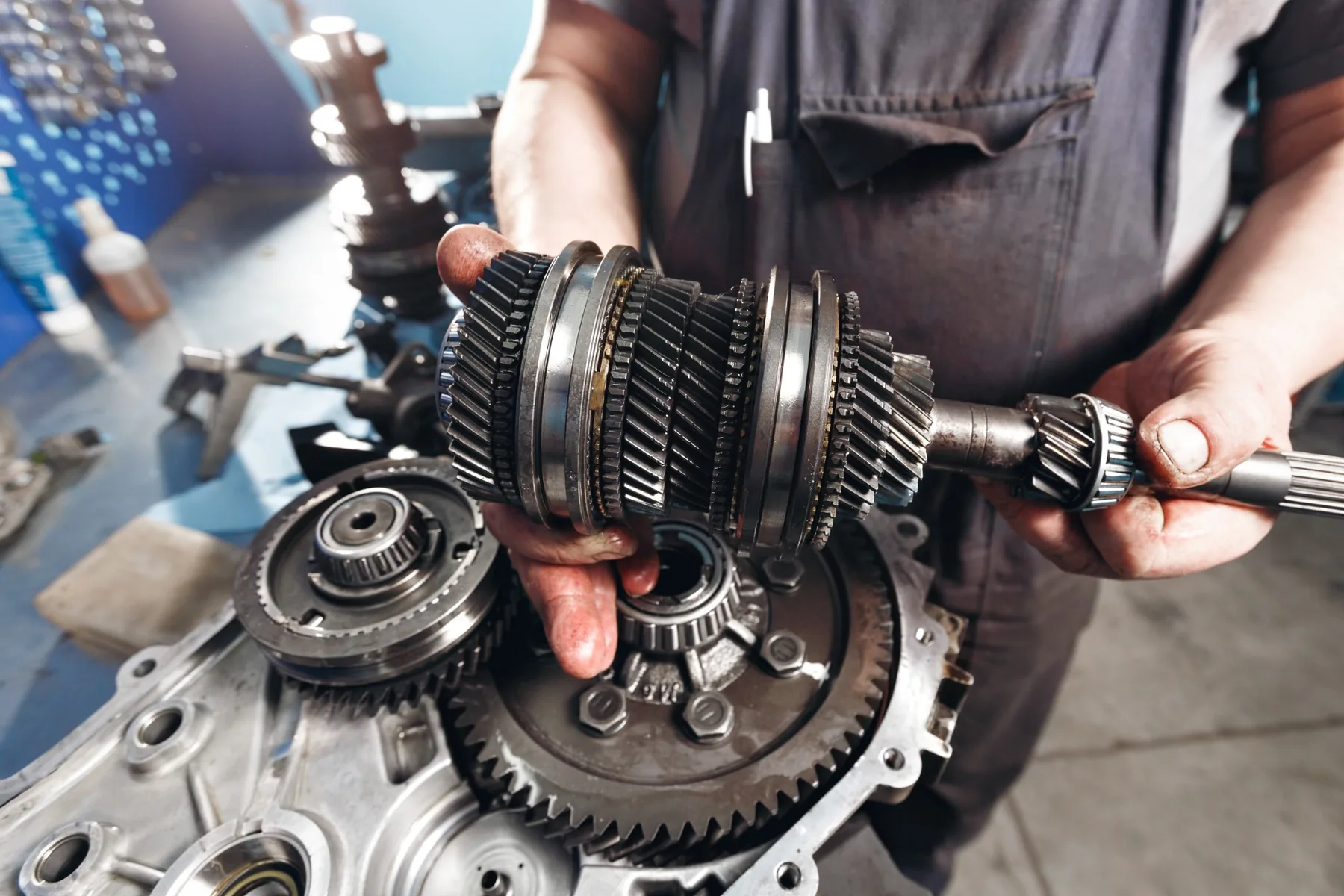 Technician holding a transmission gear assembly during a rebuild