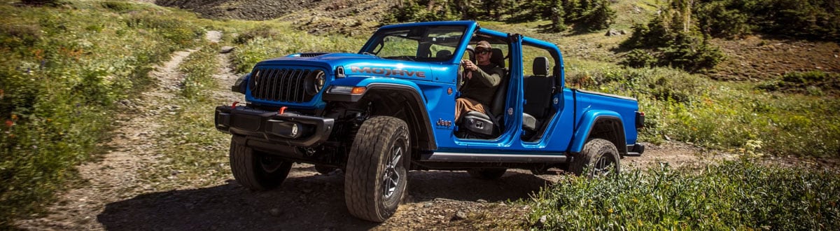 Blue Jeep Gladiator Driving on a Trail