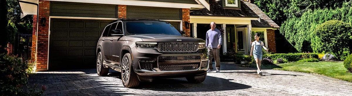 Jeep Grand Cherokee SUV Parked in a Driveway on a Spring Day